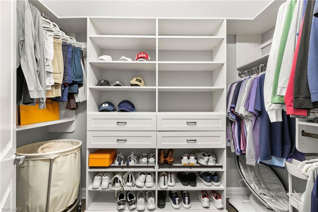 4308 Caldera Circle Naples, FL 34119 - Photo 22 of 44 a view of walk in closet with clothes and shoes
