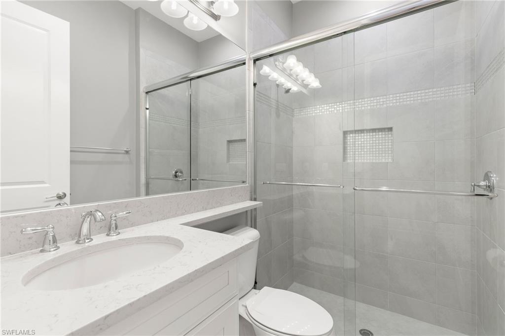 4308 Caldera Circle Naples, FL 34119 - Photo 24 of 44 a bathroom with a sink toilet and shower