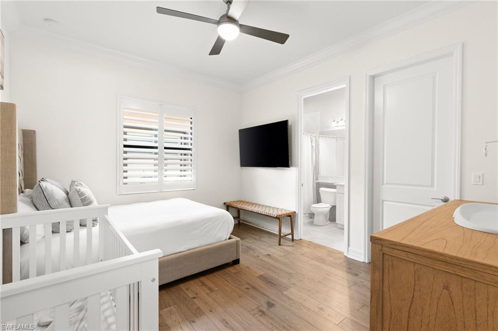 4308 Caldera Circle Naples, FL 34119 - Photo 25 of 44 a bedroom with a bed and a flat screen tv