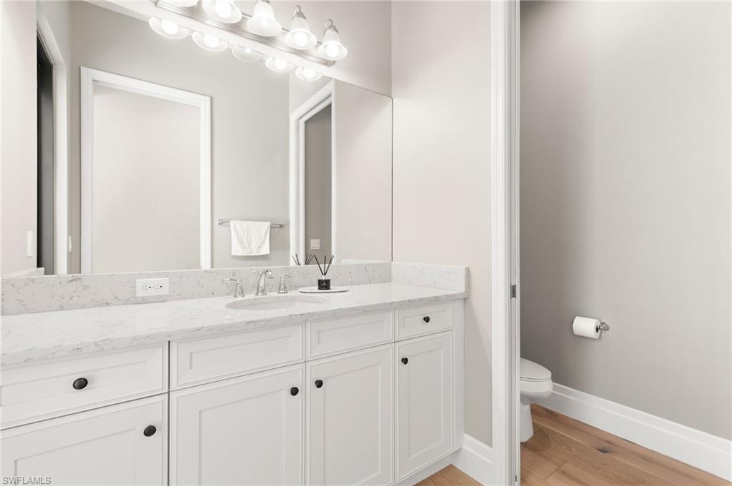 4308 Caldera Circle Naples, FL 34119 - Photo 32 of 44 a bathroom with a double vanity sink and a mirror