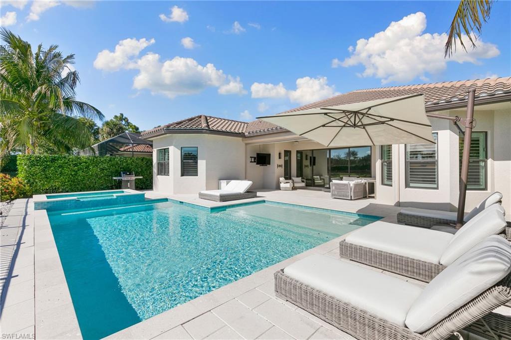 4308 Caldera Circle Naples, FL 34119 - Photo 36 of 44 a front view of a house with garden