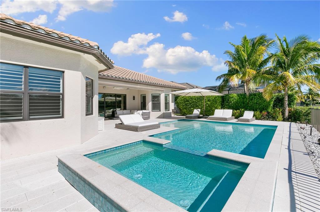 4308 Caldera Circle Naples, FL 34119 - Photo 38 of 44 a view of house with swimming pool outdoor seating