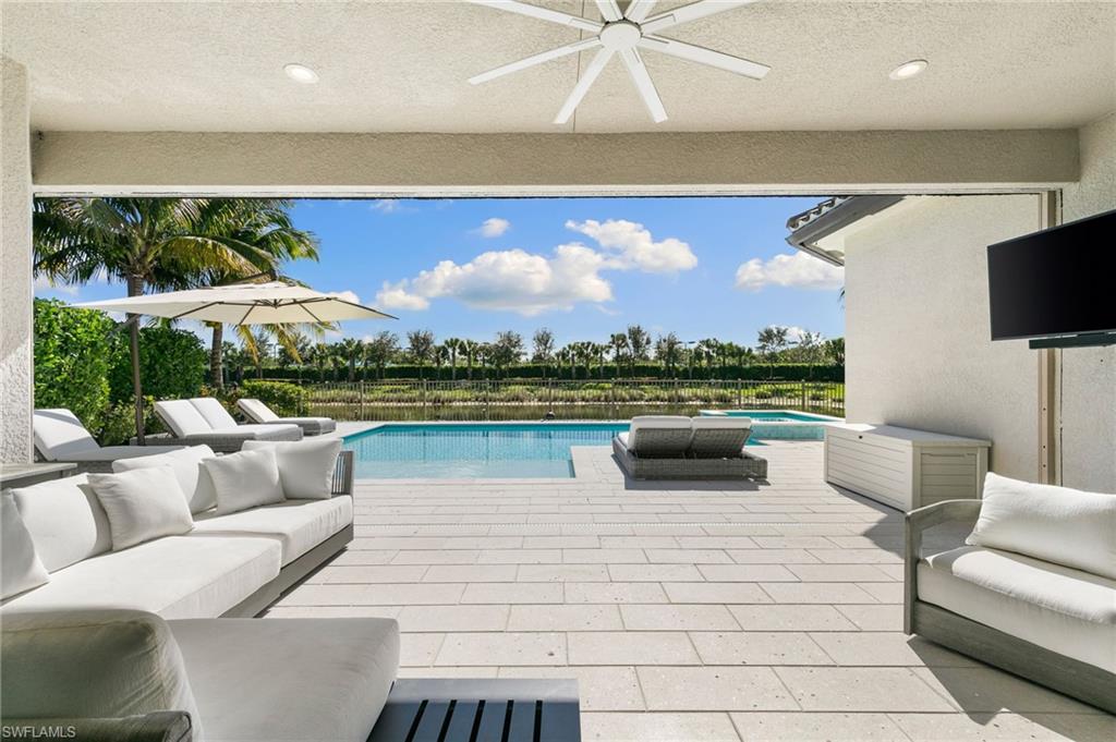 4308 Caldera Circle Naples, FL 34119 - Photo 40 of 44 a living room with furniture and a flat screen tv
