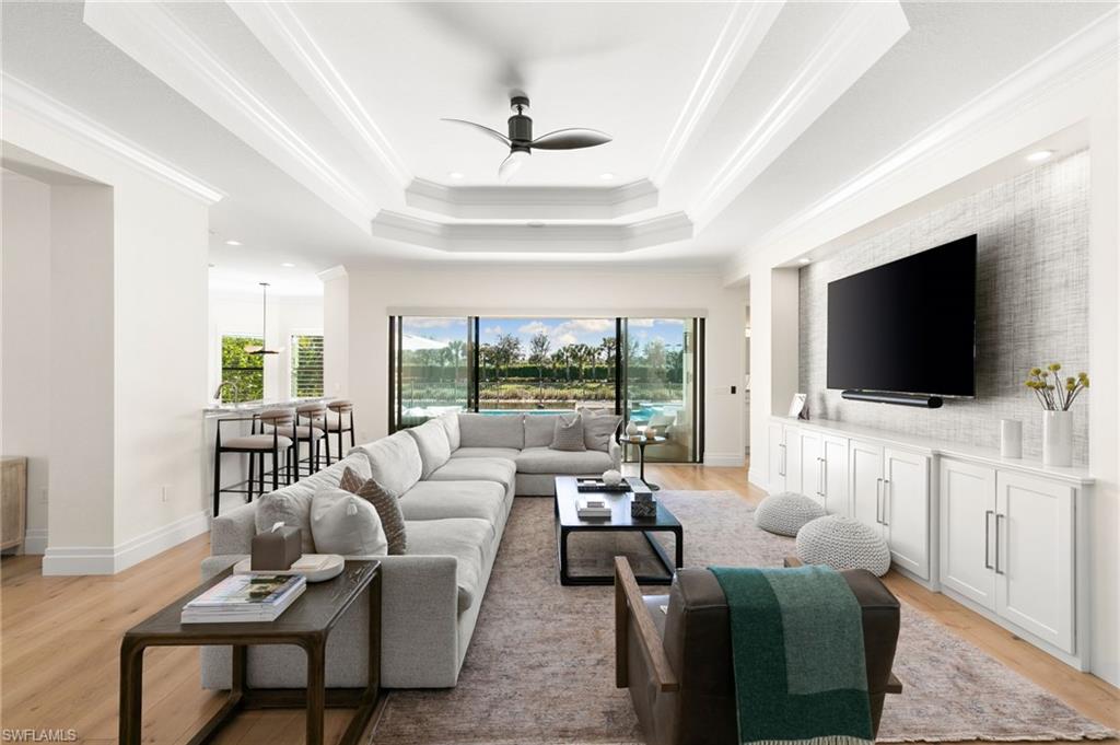 4308 Caldera Circle Naples, FL 34119 - Photo 4 of 44 a living room with furniture and a flat screen tv