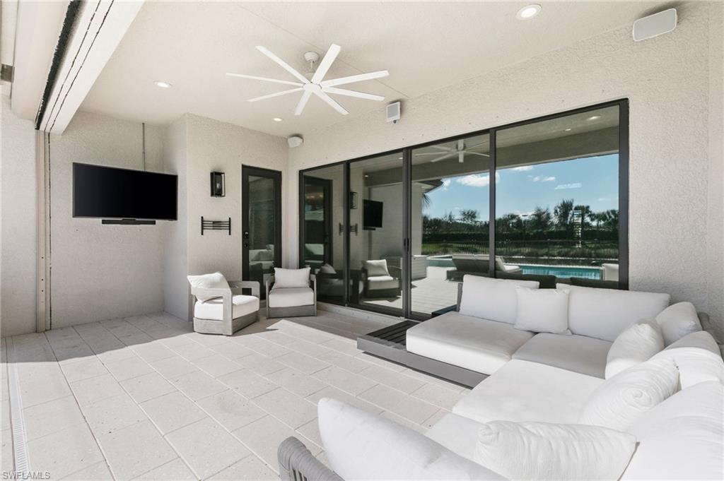 4308 Caldera Circle Naples, FL 34119 - Photo 41 of 44 a living room with furniture and a flat screen tv