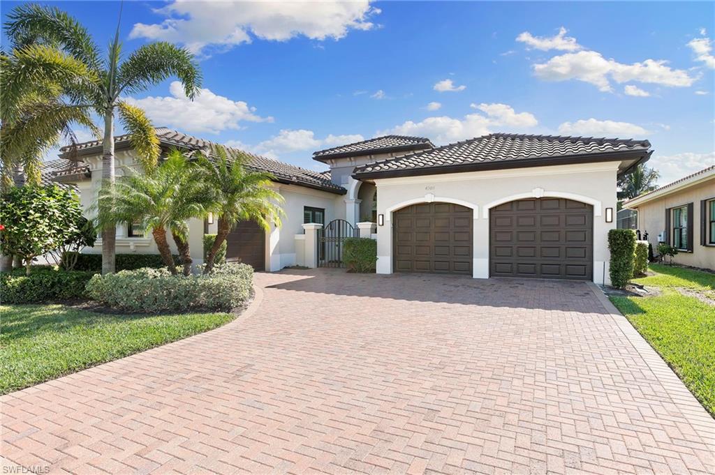 4308 Caldera Circle Naples, FL 34119 - Photo 42 of 44 a front view of a house with a yard and garage