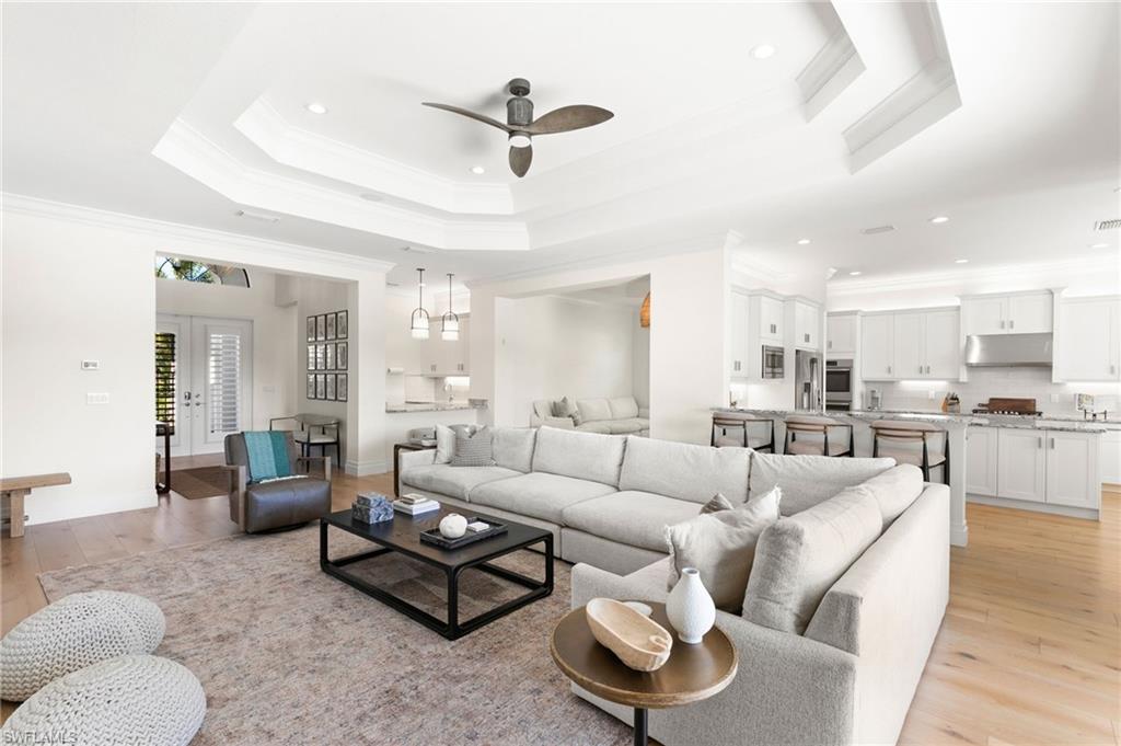 4308 Caldera Circle Naples, FL 34119 - Photo 5 of 44 a living room with furniture kitchen view and a chandelier
