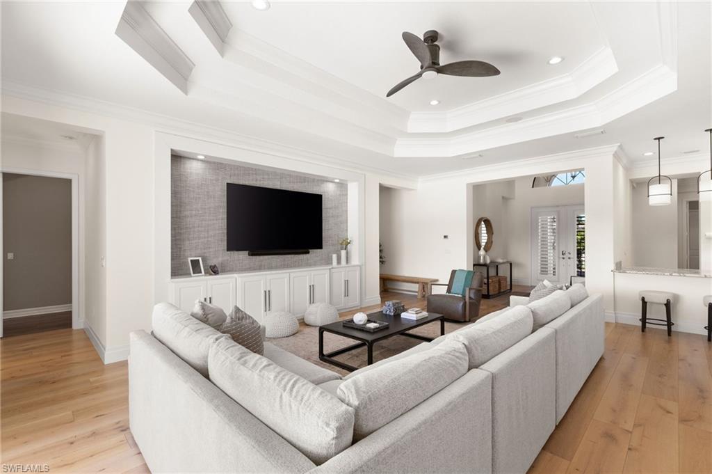 4308 Caldera Circle Naples, FL 34119 - Photo 7 of 44 a living room with furniture and a flat screen tv