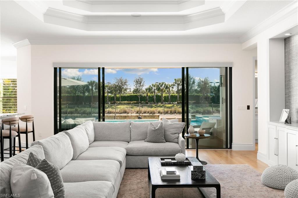 4308 Caldera Circle Naples, FL 34119 - Photo 9 of 44 a living room with furniture and a large window