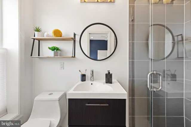 a bathroom with a toilet a sink and a mirror