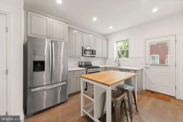 a kitchen with a sink stove and refrigerator