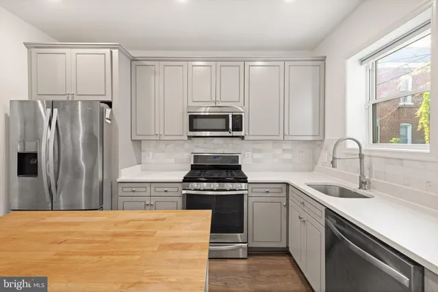 a kitchen with a stove a sink and a refrigerator
