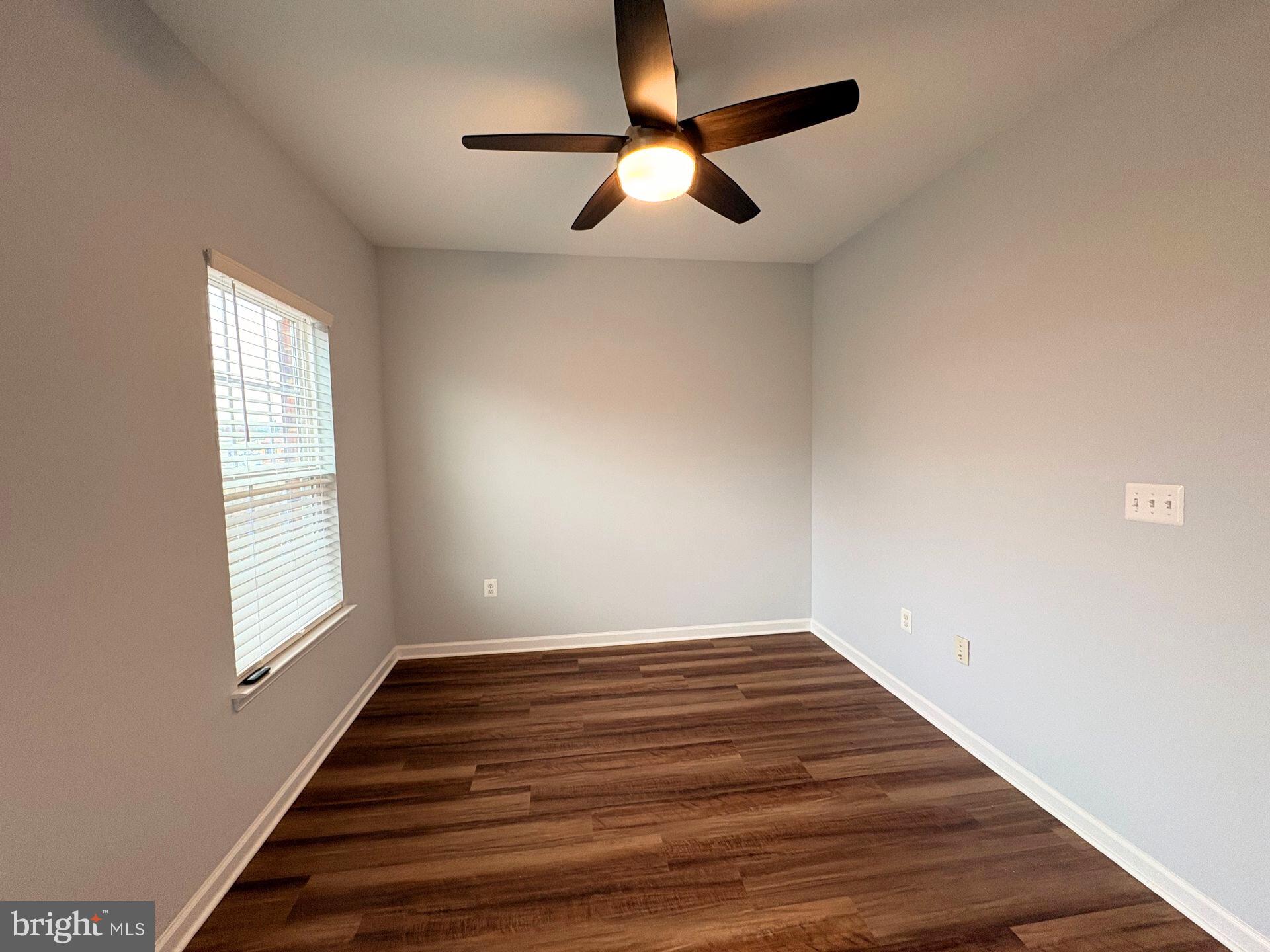 1718 Featherstone Road Woodbridge, VA 22191 - Photo 15 of 23 an empty room with wooden floor fan and windows