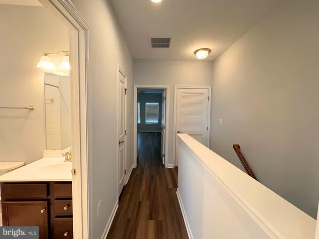 a view of hallway with wooden floor