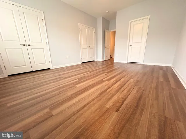 a view of a room with wooden floor and closet
