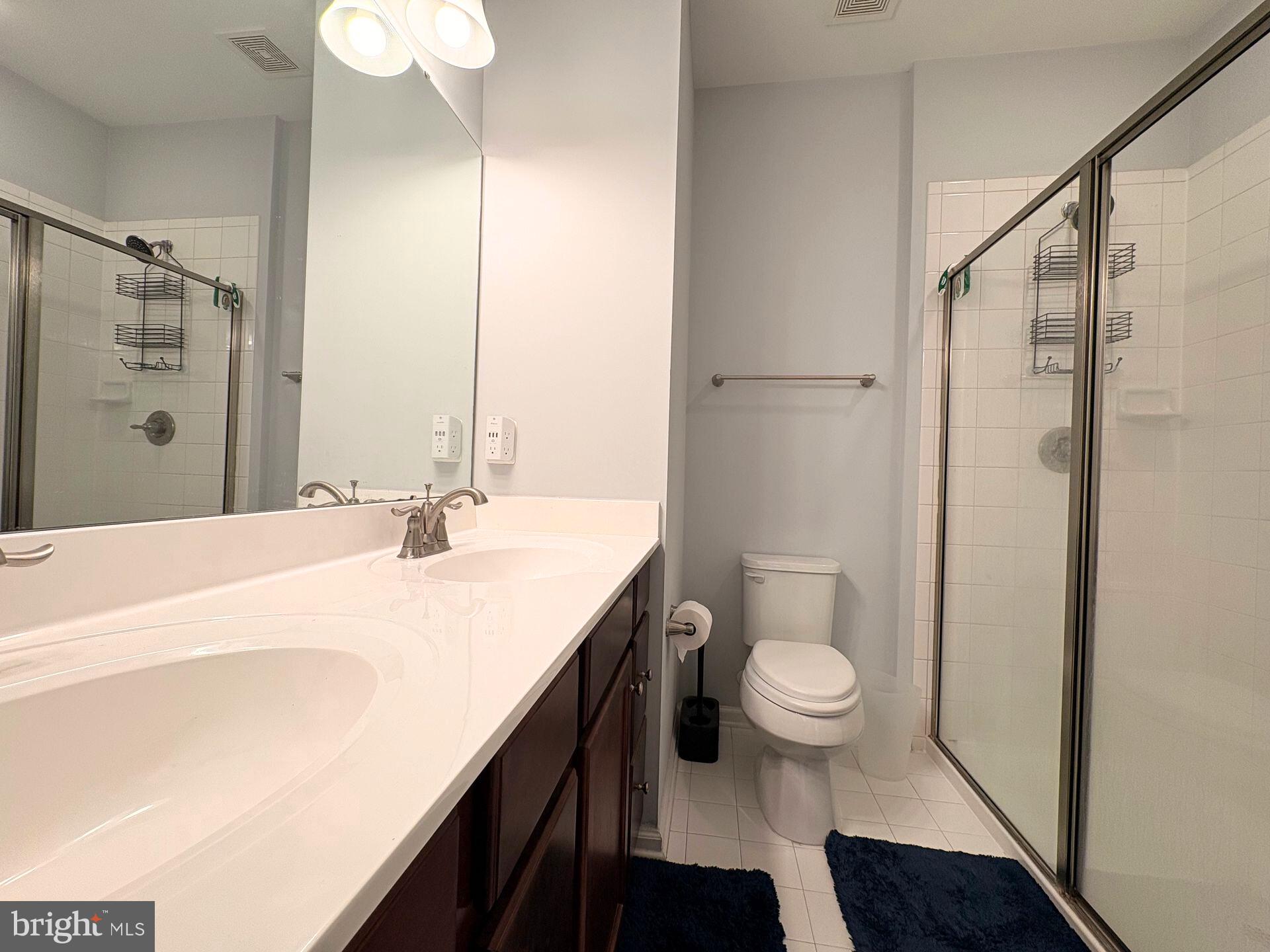 1718 Featherstone Road Woodbridge, VA 22191 - Photo 20 of 23 a bathroom with a sink a toilet a shower and a mirror