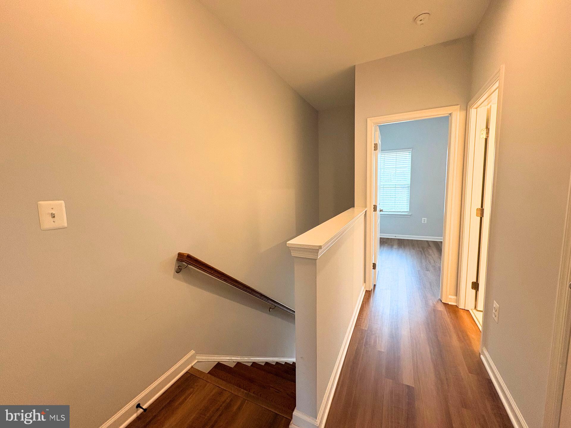 1718 Featherstone Road Woodbridge, VA 22191 - Photo 21 of 23 a view of a hallway with wooden floor