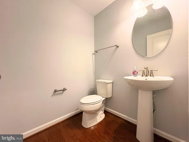 a bathroom with a sink toilet and a mirror