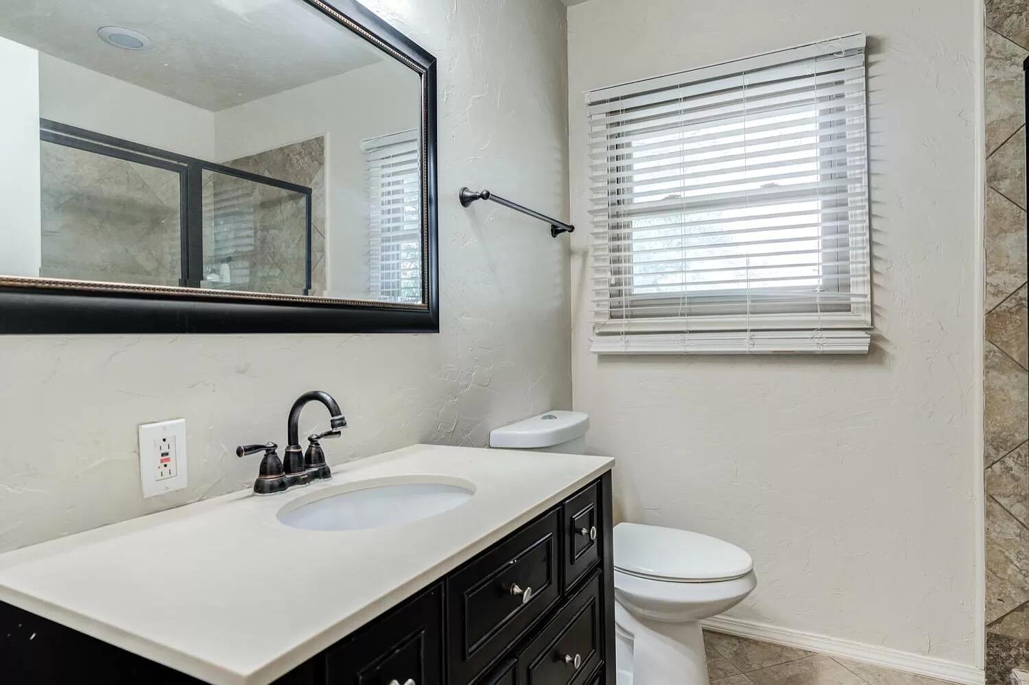3204 28th Street Lubbock, TX 79410 - Photo 14 of 24 a bathroom with a sink and a toilet