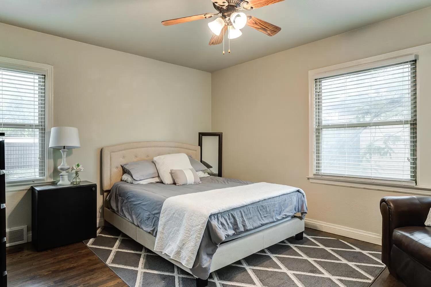 3204 28th Street Lubbock, TX 79410 - Photo 16 of 24 a bedroom with a bed and wooden floor