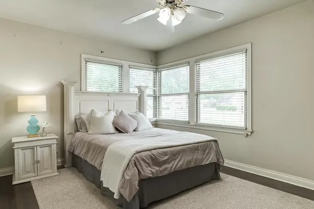 a bedroom with a large bed and a chandelier
