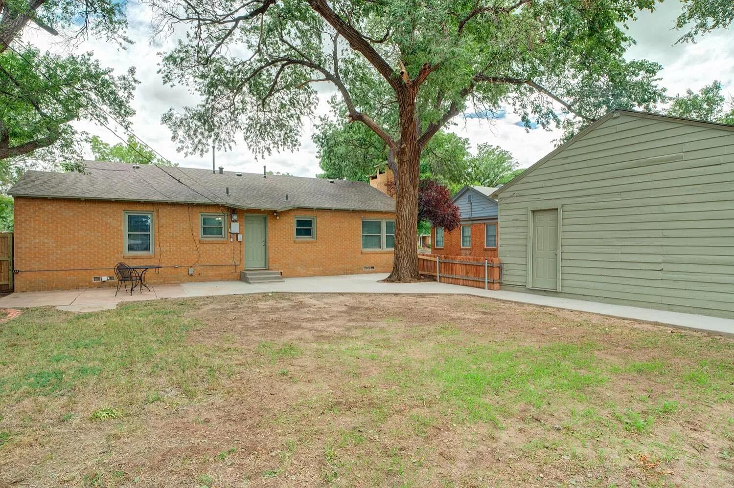 3204 28th Street Lubbock, TX 79410 - Photo 21 of 24 a view of a backyard with a garden and tree