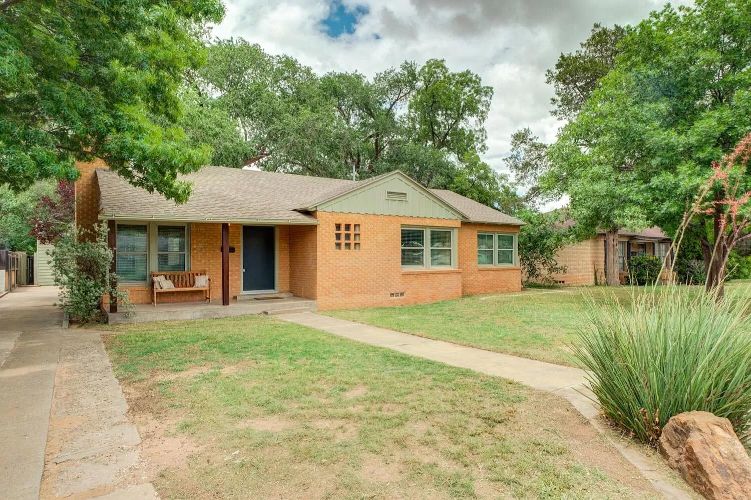 3204 28th Street Lubbock, TX 79410 - Photo 3 of 24 a front view of a house with a garden