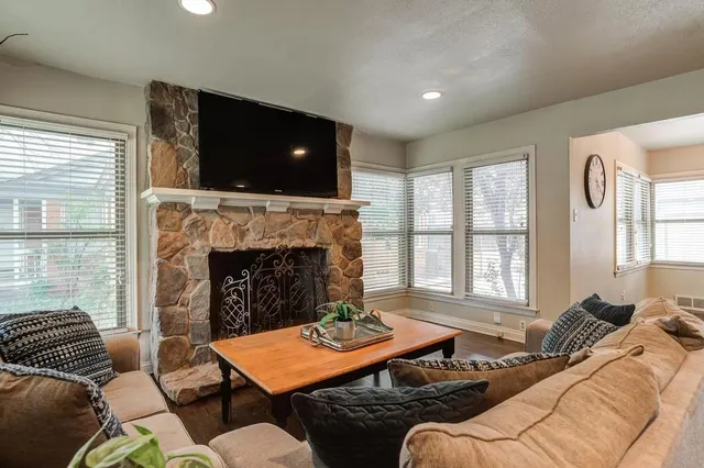a living room with furniture and a fireplace