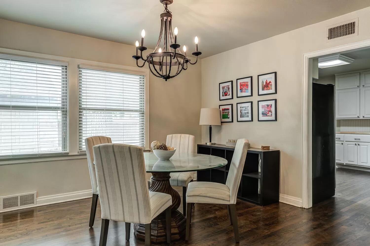 3204 28th Street Lubbock, TX 79410 - Photo 7 of 24 a view of a dining room with furniture wooden floor and chandelier