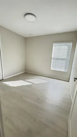 an empty room with a empty space and a window