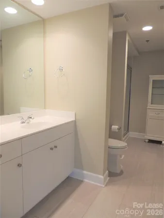 a bathroom with a glass shower door