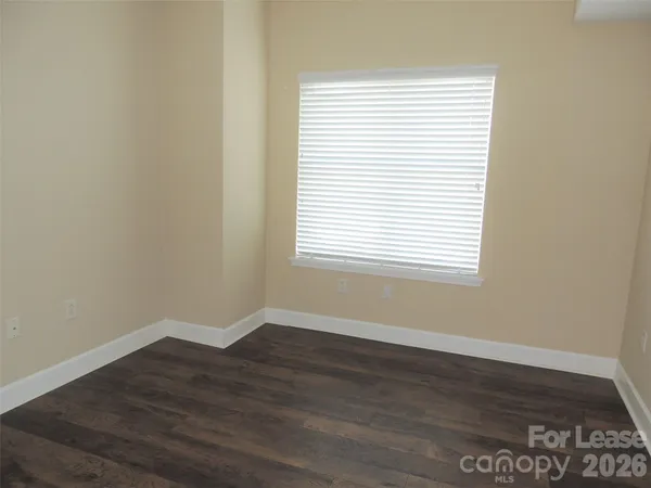 an empty room with wooden floor