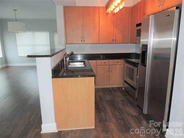 a kitchen with a refrigerator and cabinets