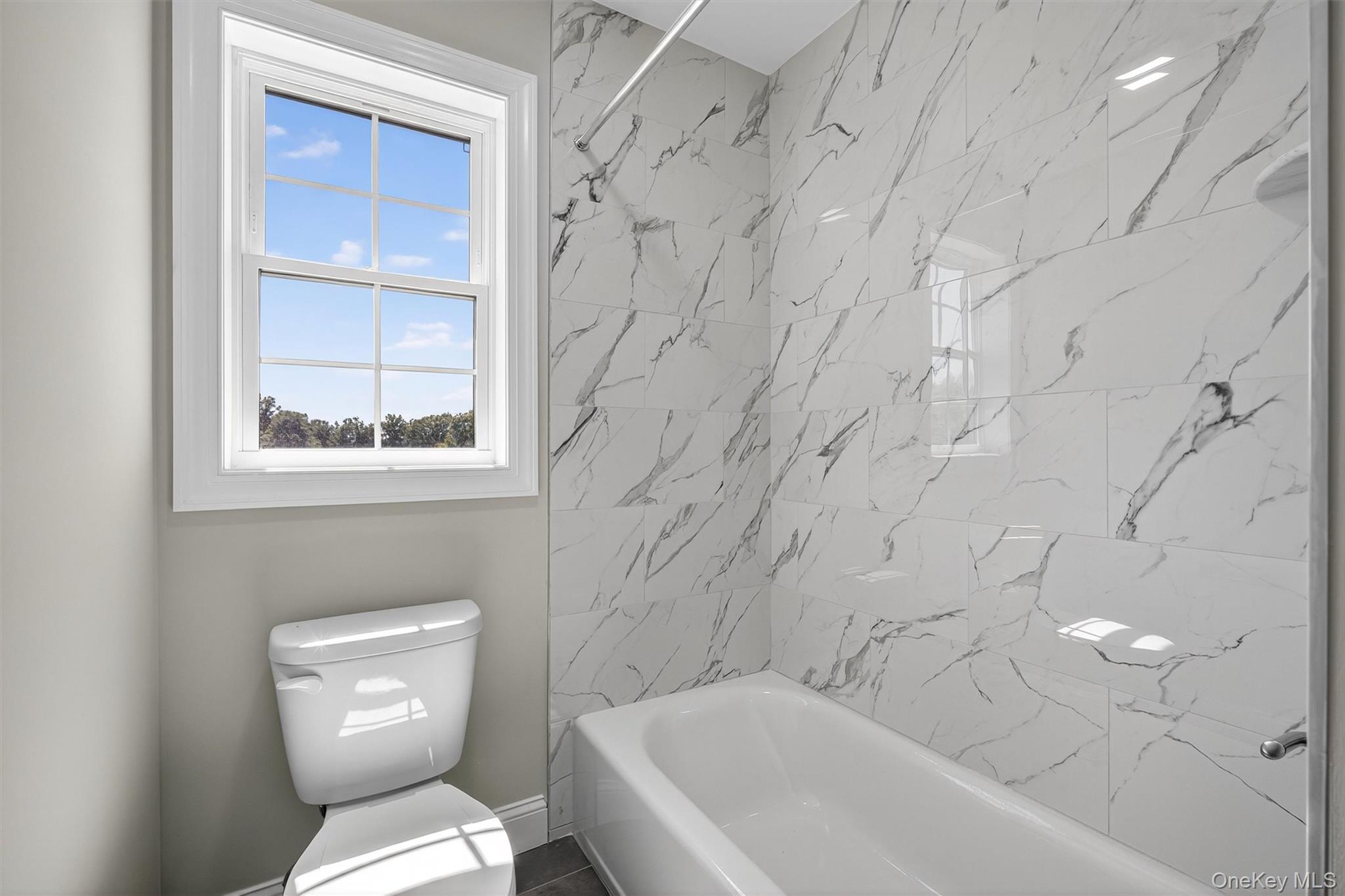 65 Kings Hill Road Walden, NY 12586 - Photo 31 of 41 a white toilet sitting next to a bath tub and a shower