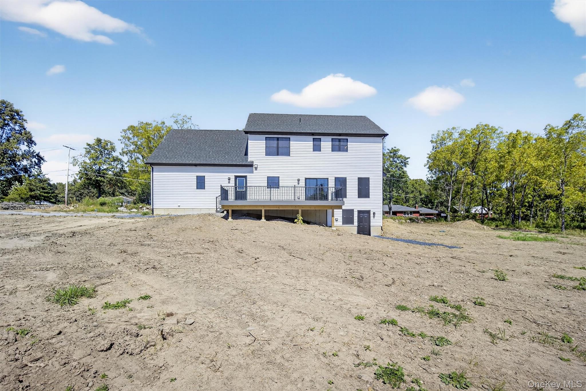 65 Kings Hill Road Walden, NY 12586 - Photo 38 of 41 a front view of a house with a yard covered with trees