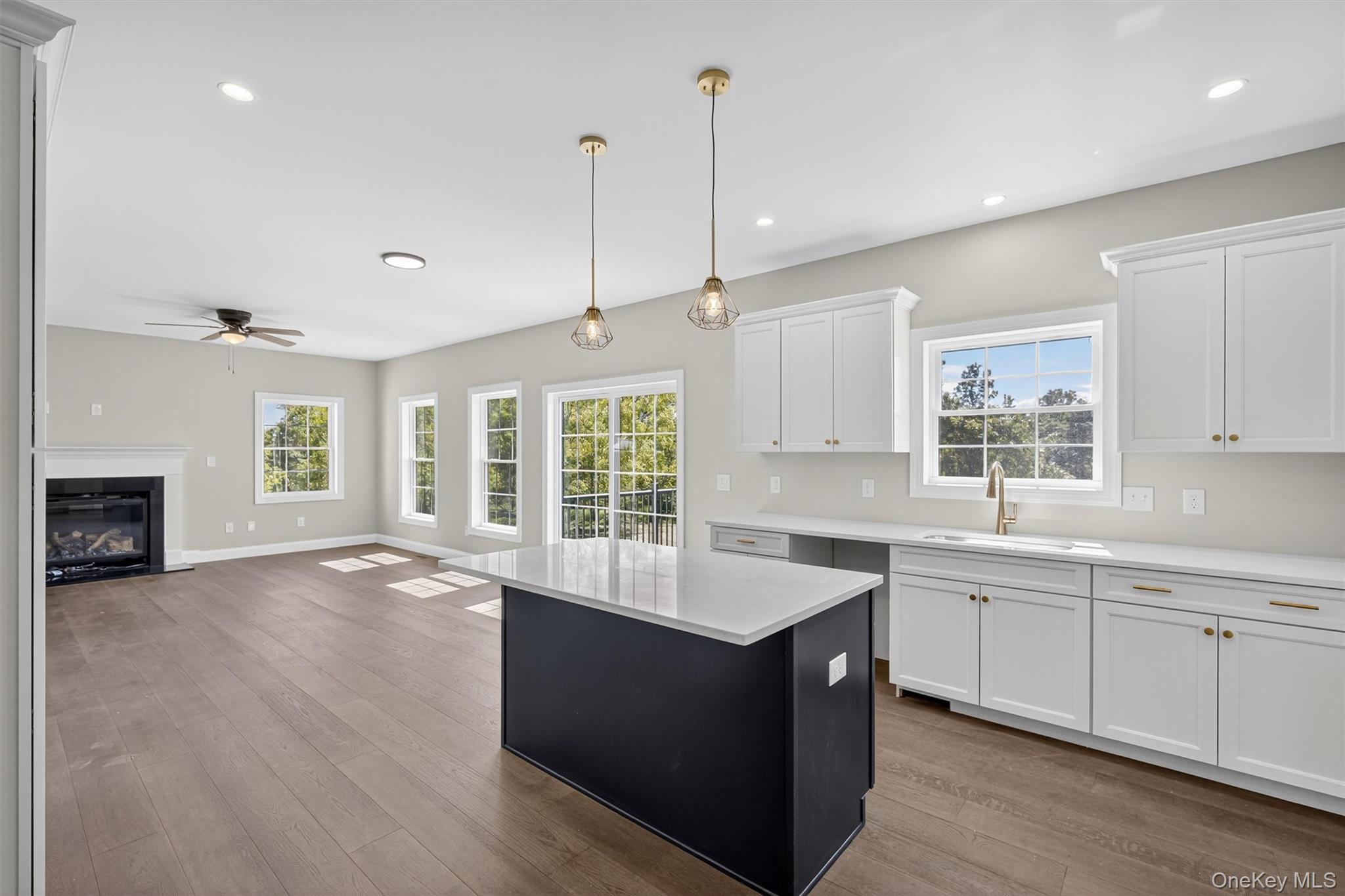 65 Kings Hill Road Walden, NY 12586 - Photo 9 of 41 a large kitchen with kitchen island a sink wooden floor and a large window