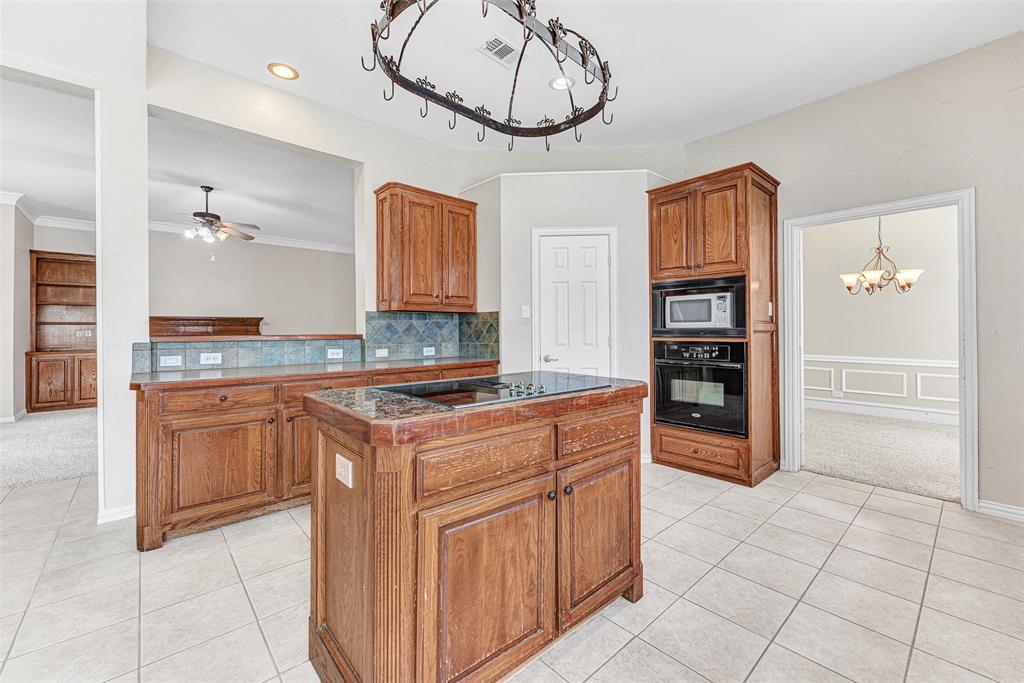 3500 Neiman Road Plano, TX 75025 - Photo 13 of 29 a kitchen with stainless steel appliances granite countertop a stove and a refrigerator