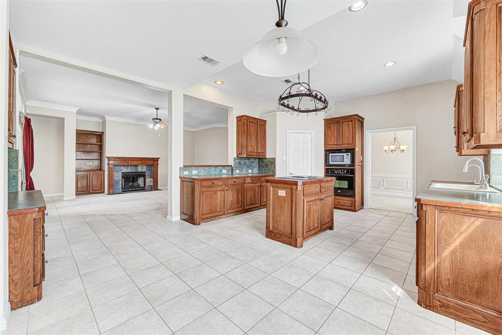 3500 Neiman Road Plano, TX 75025 - Photo 15 of 29 a kitchen with stainless steel appliances granite countertop a stove top oven a sink a counter top space and cabinets