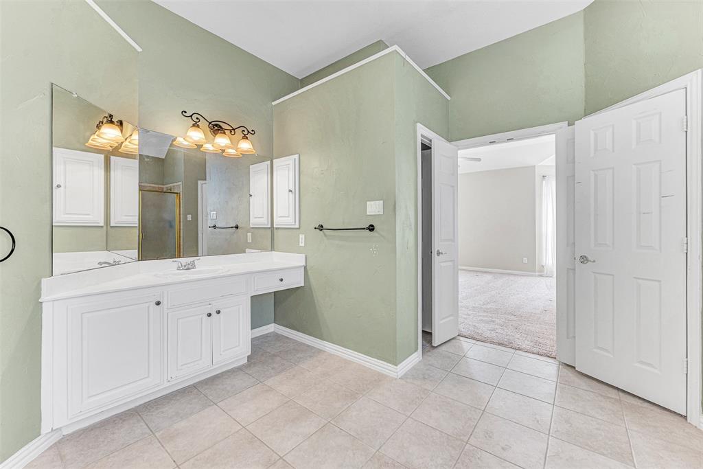 3500 Neiman Road Plano, TX 75025 - Photo 20 of 29 a spacious bathroom with a double vanity sink a mirror and a shower