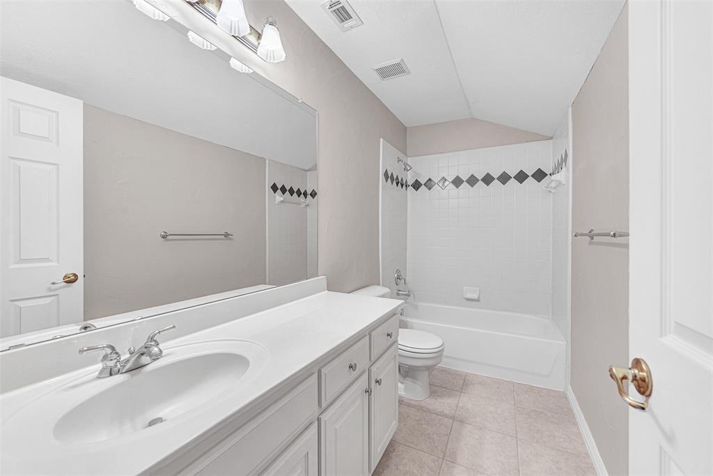 3500 Neiman Road Plano, TX 75025 - Photo 24 of 29 a bathroom with a sink a toilet a mirror and shower