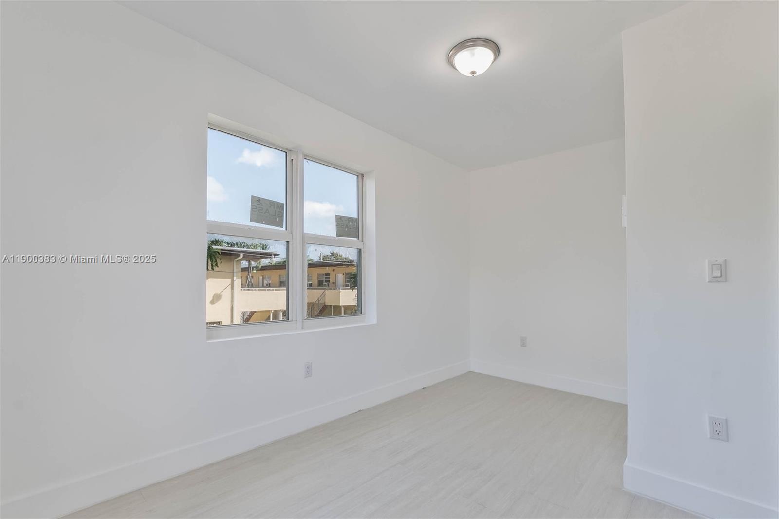 1051 Northwest 2nd Street, Unit 12 Miami, FL 33128 - Photo 13 of 14 an empty room with a window