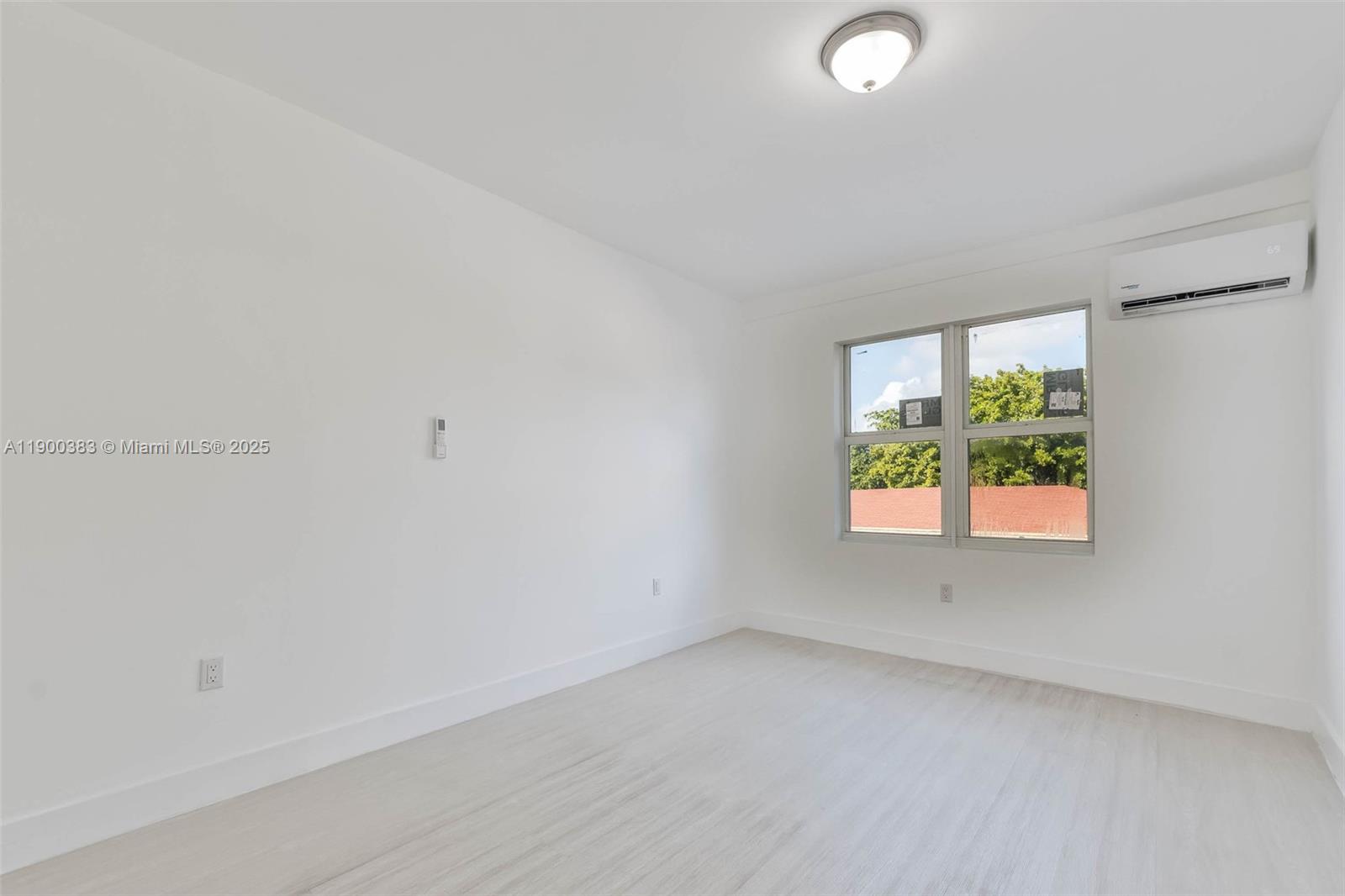 1051 Northwest 2nd Street, Unit 12 Miami, FL 33128 - Photo 10 of 14 an empty room with windows