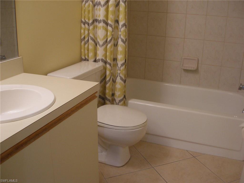 3342 Timberwood Circle Naples, FL 34105 - Photo 14 of 17 a bathroom with a sink a toilet and bathtub