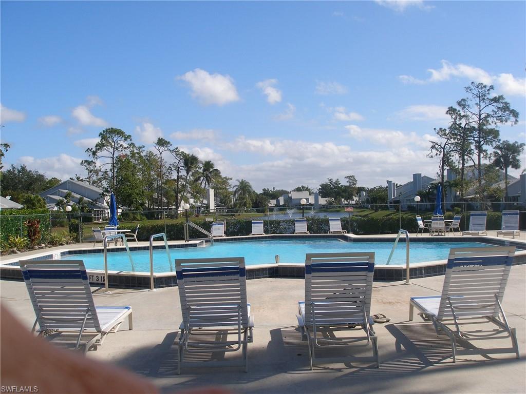 3342 Timberwood Circle Naples, FL 34105 - Photo 15 of 17 a view of a lake with couches and city view