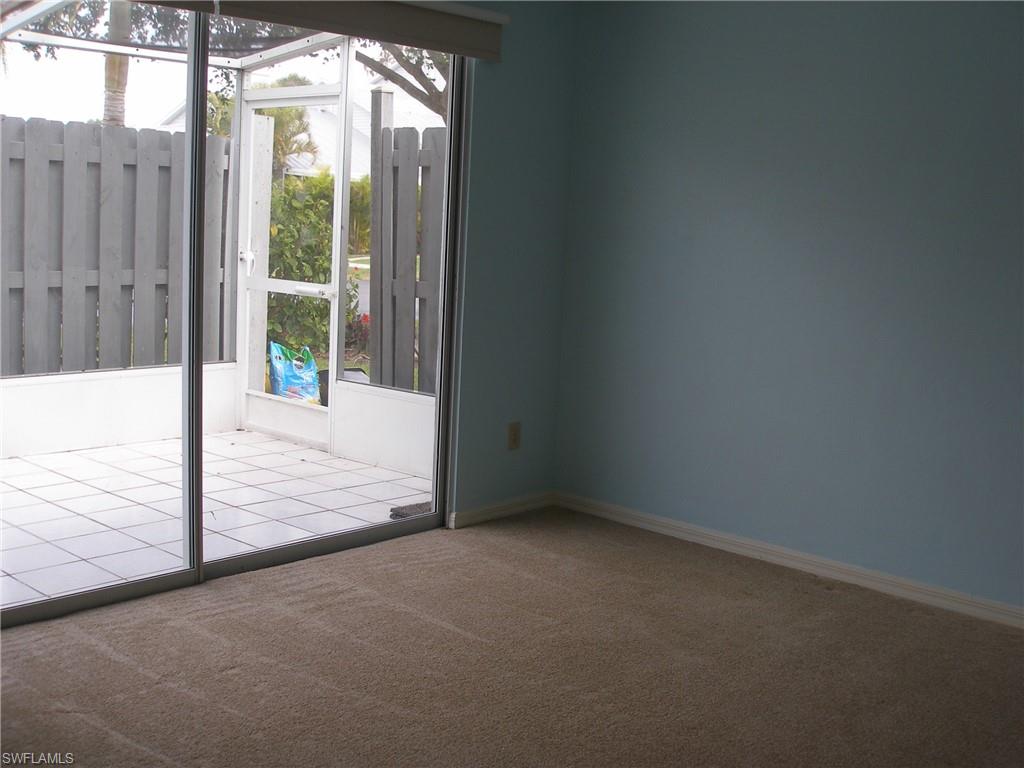 3342 Timberwood Circle Naples, FL 34105 - Photo 9 of 17 a view of an empty room and window
