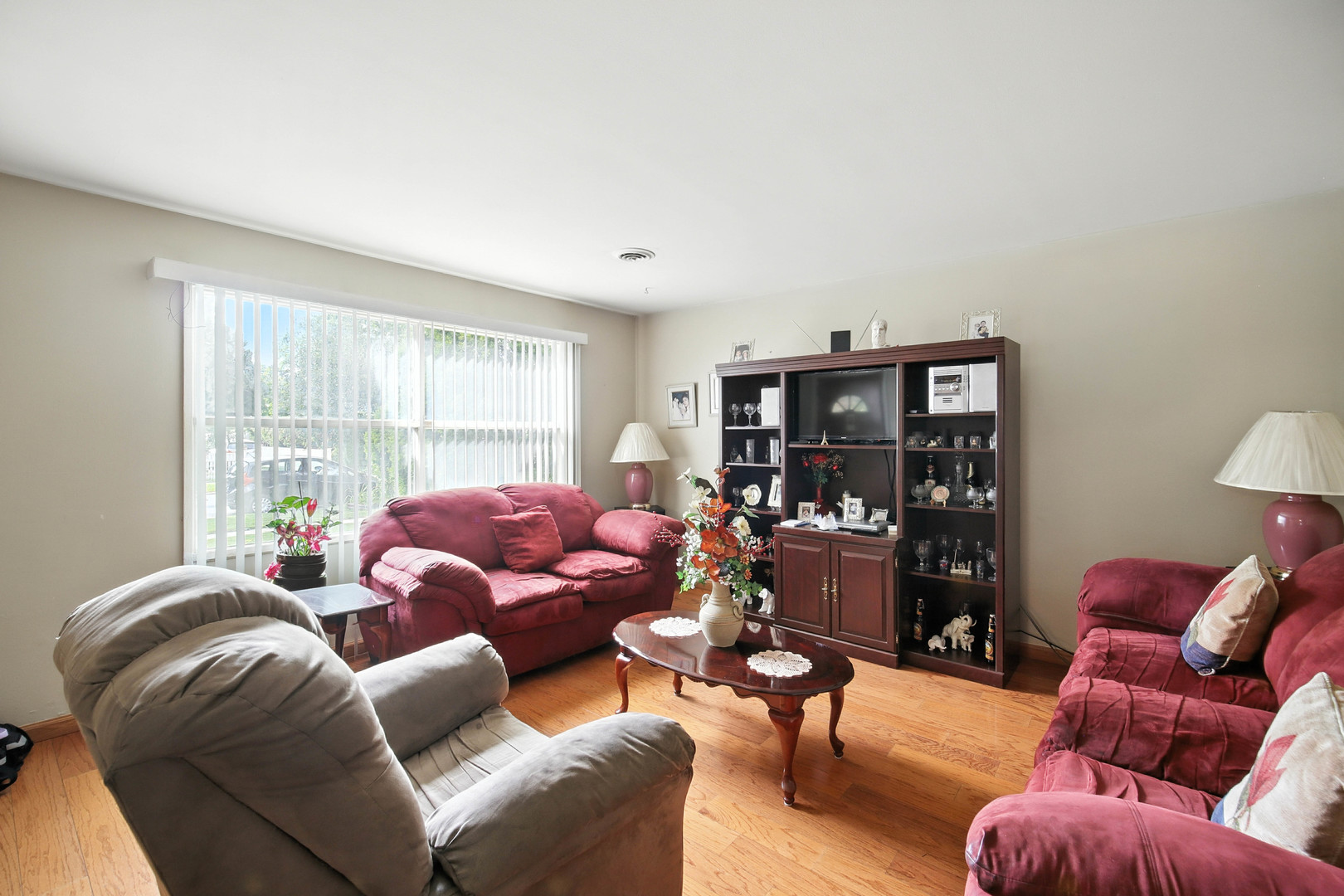 295 East Dennis Road Wheeling, IL 60090 - Photo 3 of 24 a living room with furniture floor to ceiling window and a flat screen tv