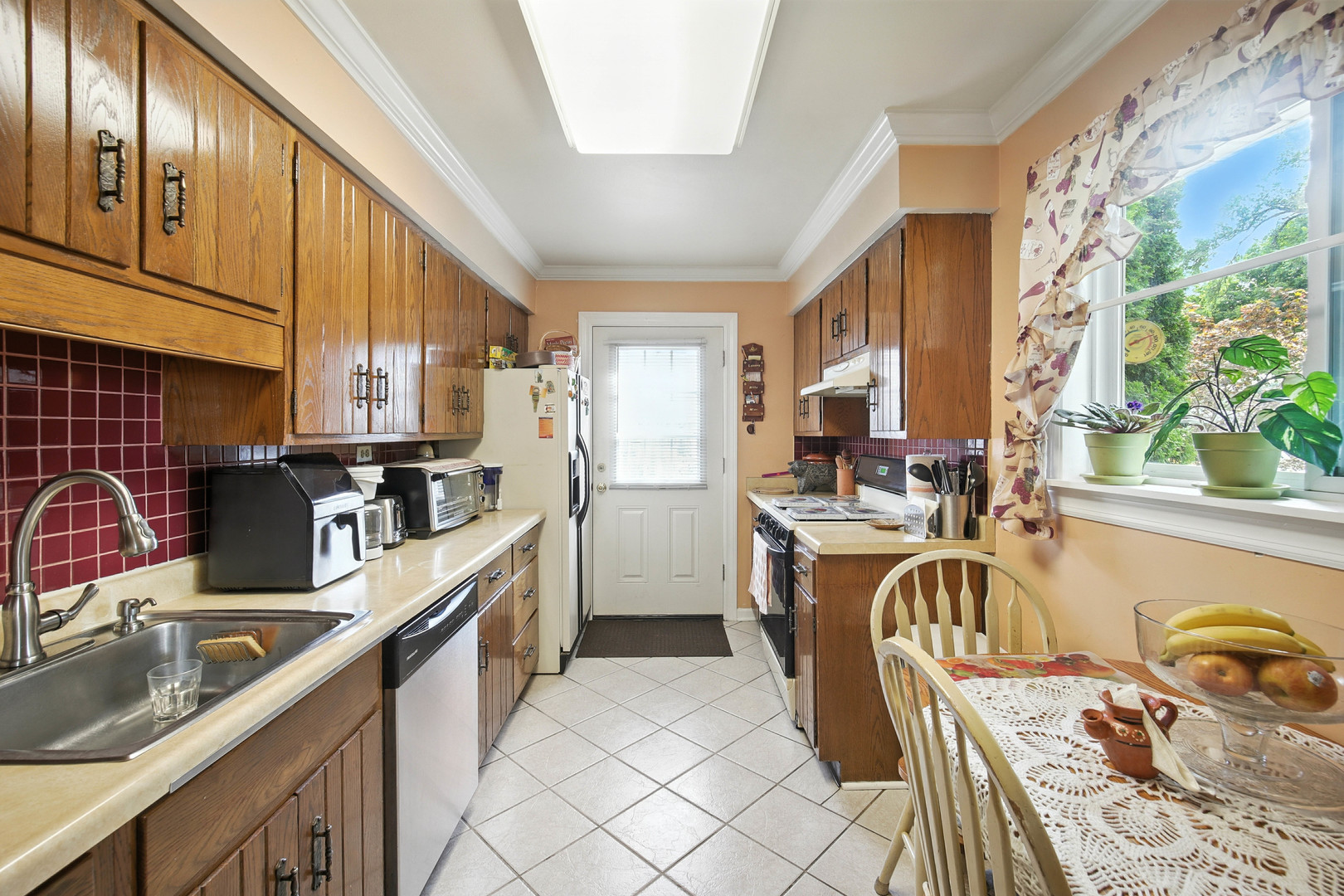 295 East Dennis Road Wheeling, IL 60090 - Photo 7 of 24 a kitchen with a sink stove and refrigerator