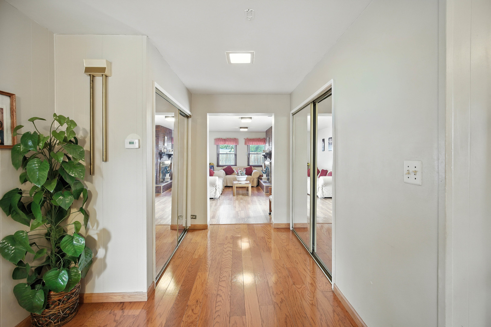 295 East Dennis Road Wheeling, IL 60090 - Photo 8 of 24 a view of a hallway view with wooden floor and living room