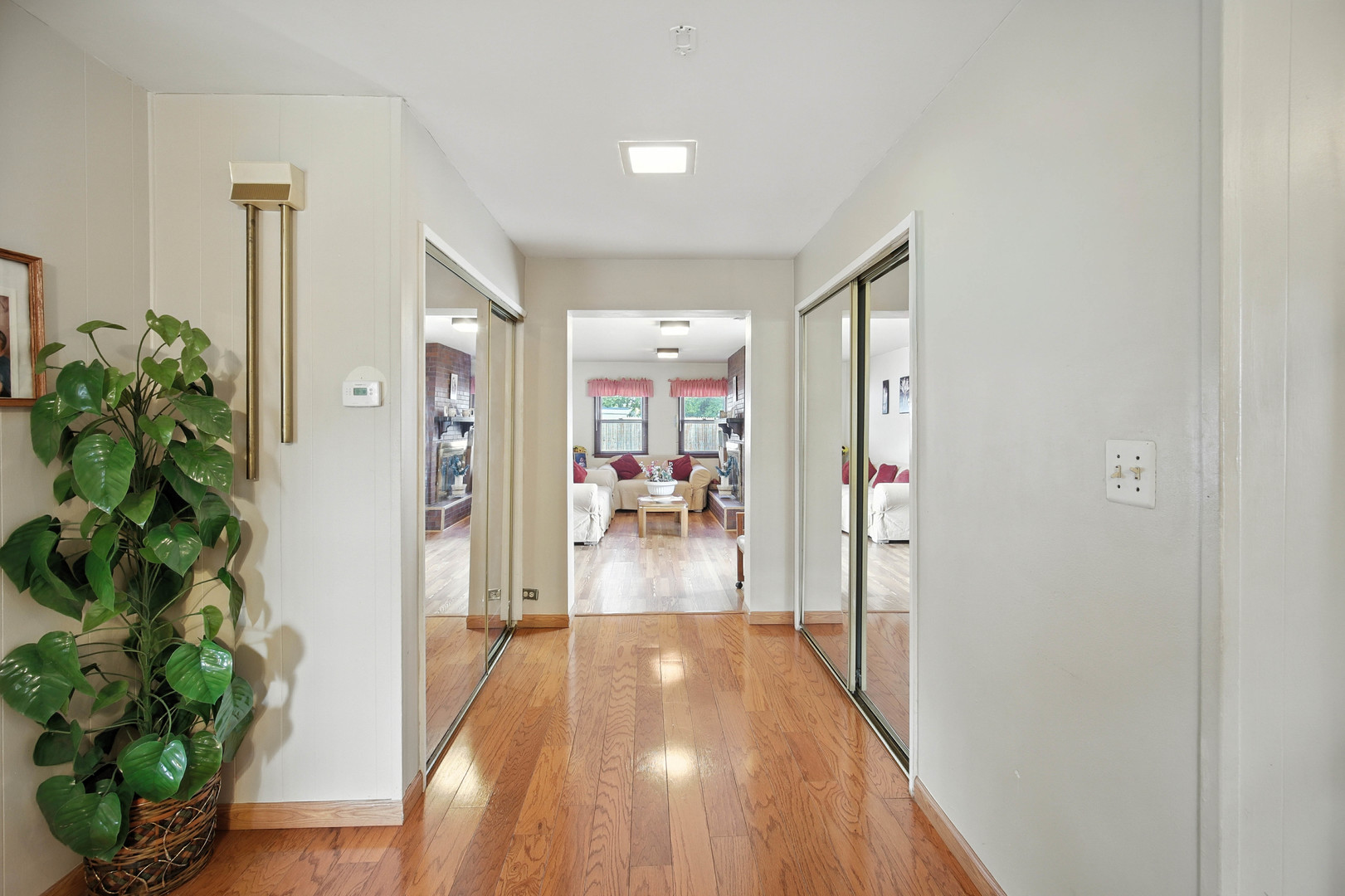 295 East Dennis Road Wheeling, IL 60090 - Photo 10 of 24 a view of a hallway view with wooden floor and living room