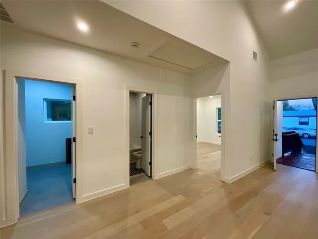 a kitchen with kitchen island granite countertop a sink appliances cabinets and furniture